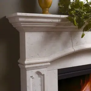 A fireplace with a white marble mantle and a yellow vase.