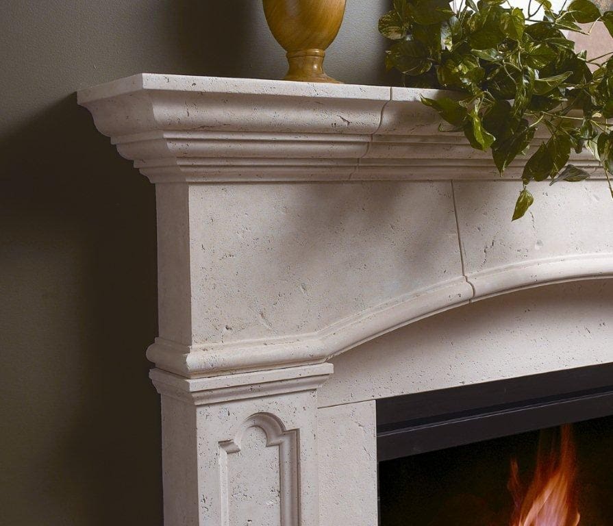 A fireplace with a white marble mantle and a yellow vase.