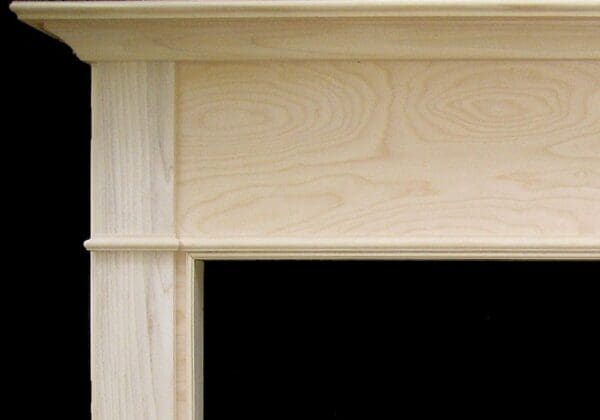 A close up of the door frame of a fireplace.