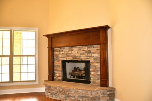 A fireplace with a brick surround and stone hearth.