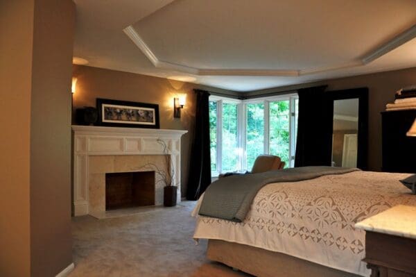 A bedroom with a fireplace and a bed in it