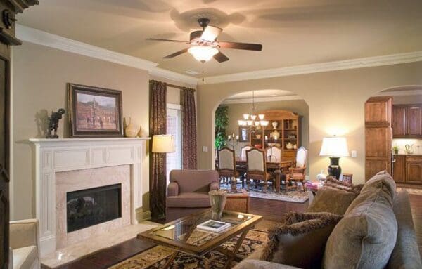 A living room with a fireplace and a dining table.