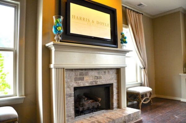 A fireplace with a television mounted above it.