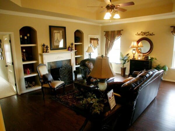 A living room with a couch, chair and fireplace.