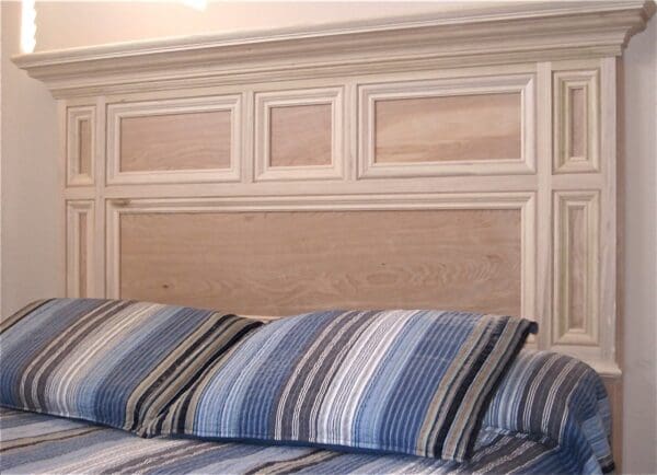 A bed with blue and white striped pillows.