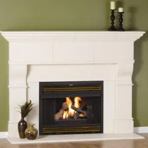 A fireplace with candles and a candle holder on the mantle.