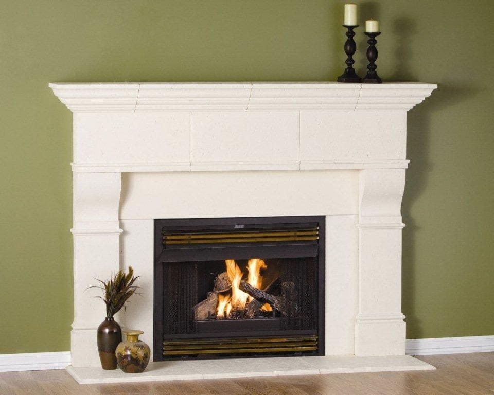 A fireplace with candles and a candle holder on the mantle.