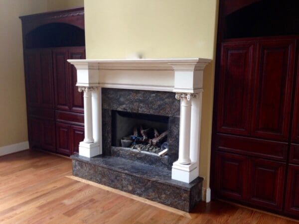 A fireplace with marble surround and white mantel.