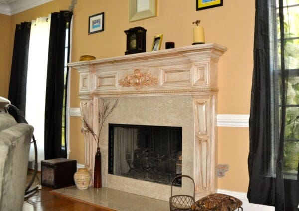 A fireplace with a mantle and mantel in the center of it.