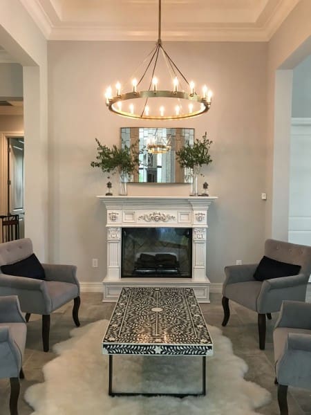 A living room with two chairs and a fireplace