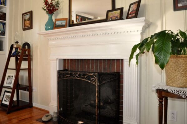 A fireplace with a mirror above it and a fire place.