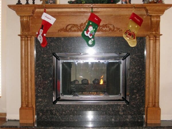 A fireplace with three stockings hanging above it.