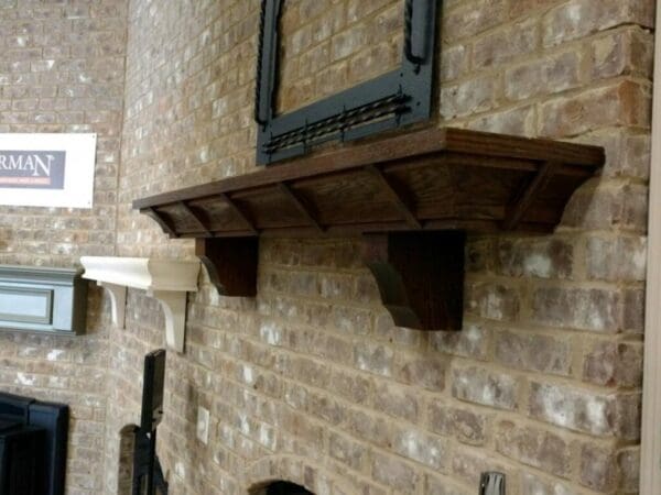 A fireplace mantle with a tv above it