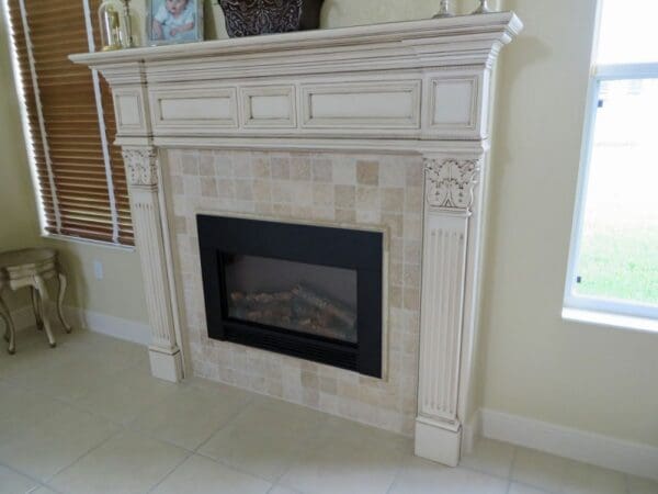 A fireplace with tile surround and mantel.