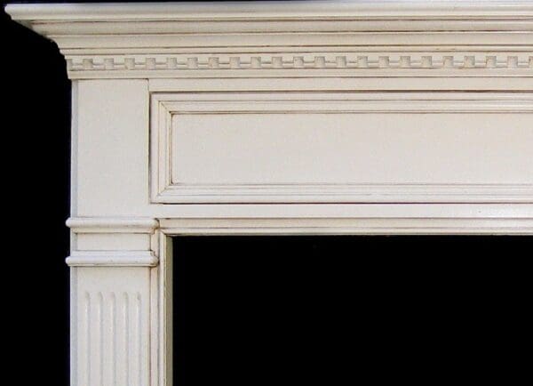 A fireplace with white trim and black background