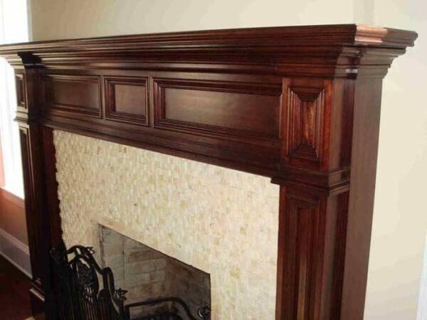 Elegant dark wood fireplace mantel.