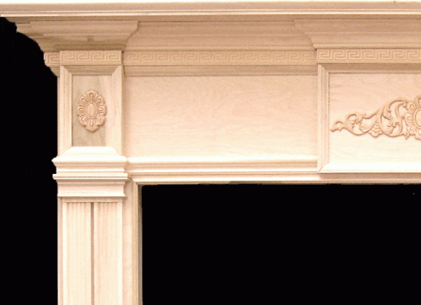 Ornate wood fireplace mantel with carvings.