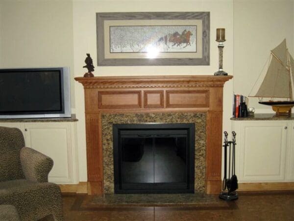 Wood fireplace mantel with granite surround.