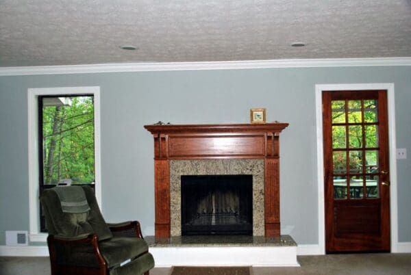 Living room with fireplace and a door.