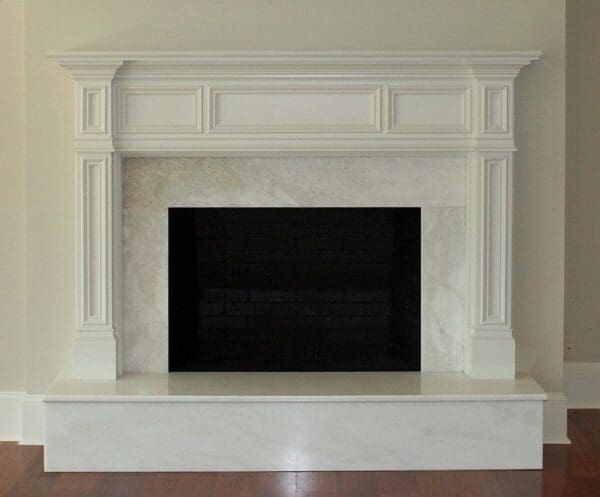 White marble fireplace with black hearth.