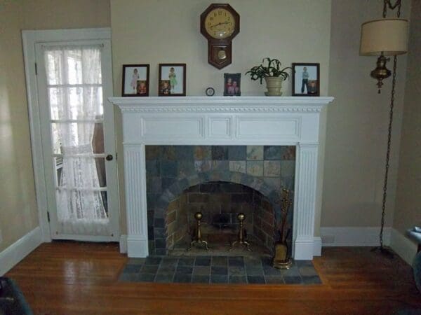 White fireplace with tiled surround.