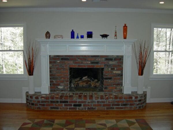 Brick fireplace with white mantel and hearth.