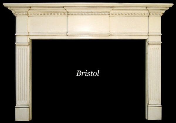 White fireplace mantel with fluted columns.