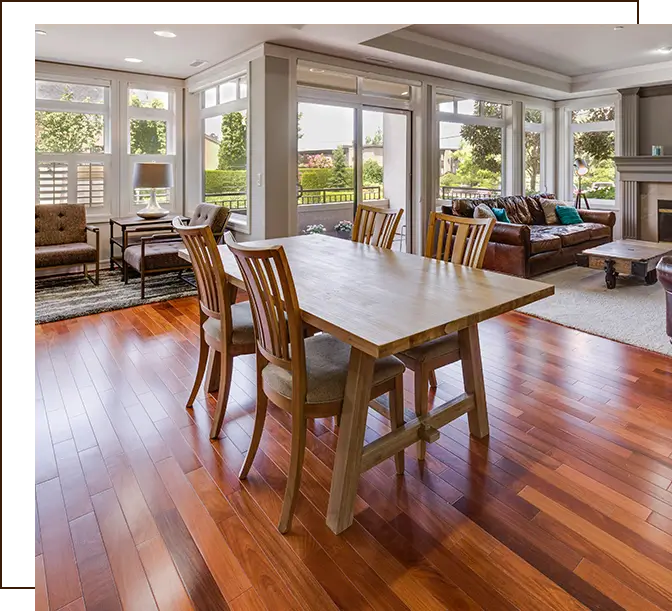 A dining room table and chairs in the middle of a living room.